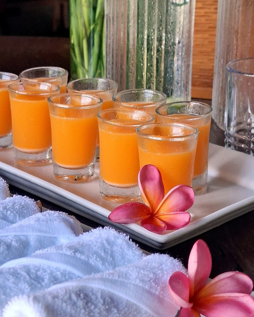 Juice, infused water and rolled towels arranged for a retreat break